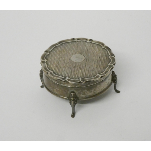 644 - A silver trinket box and hinged cover, raised on four small scrolled feet, with blue velvet lining. ... 