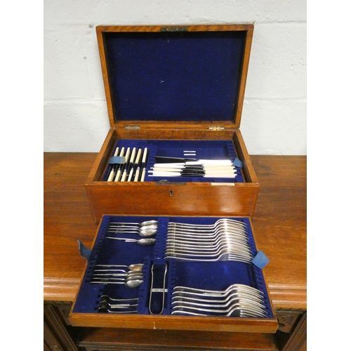 93 - A part canteen of cutlery in oak cabinet