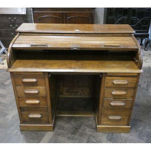 95 - An golden oak Tambour fronted roll top desk, 4' wide