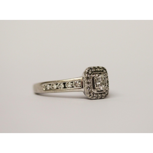 512 - A modern diamond dress ring, diamond set rectangular panel with diamond shoulders, in hallmarked pla... 