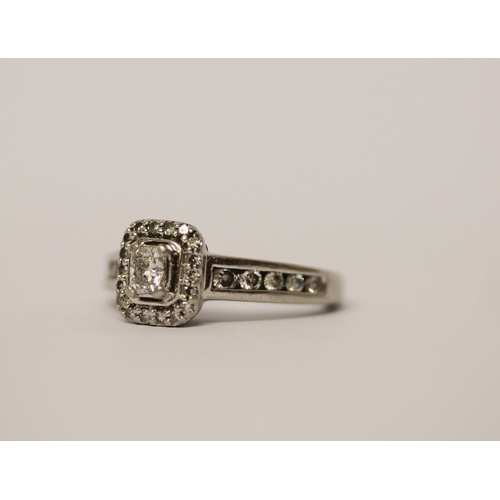 512 - A modern diamond dress ring, diamond set rectangular panel with diamond shoulders, in hallmarked pla... 