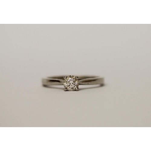 514 - A solitaire diamond engagement ring, the brilliant claw set diamond on hallmarked platinum band. Rin... 