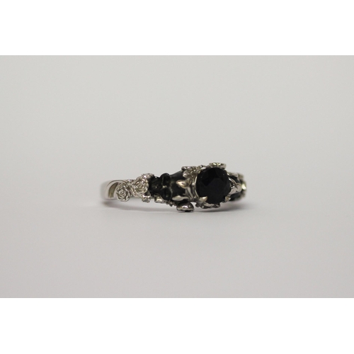 520 - Unusual sapphire Memento Mori ring, on 10k white gold band, ring size N, gross weight 5g