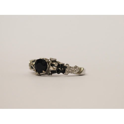 520 - Unusual sapphire Memento Mori ring, on 10k white gold band, ring size N, gross weight 5g