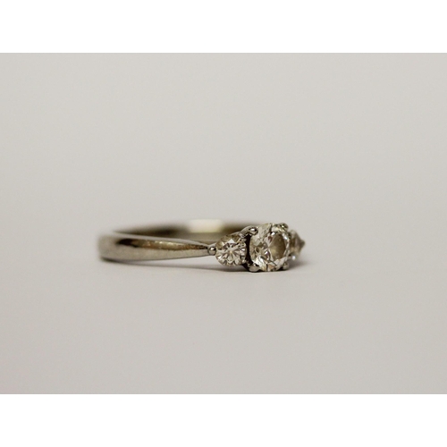 522 - A modern platinum and diamond three stone ring, hallmarked. Ring size L, weight 4.6g