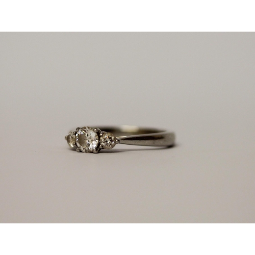 522 - A modern platinum and diamond three stone ring, hallmarked. Ring size L, weight 4.6g