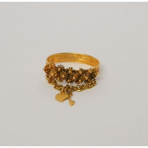 523 - High carat yellow gold cannetille dress ring with key to the heart attached. Ring size P, gross weig... 