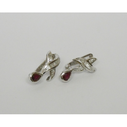 565 - A pair of modern ruby and diamond pierced earrings, with omega fittings. On 18ct white gold posts