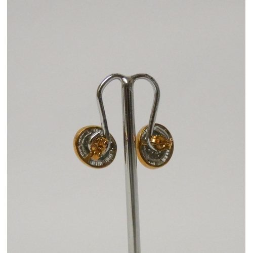 577 - A pair of 9ct gold and diamond set oval ear studs