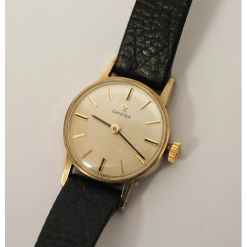 612 - Ladies Omega 9ct gold wristwatch on black leather strap