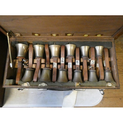 685 - 52 early 20th century campanology hand bells with leather straps, all contained within six wooden fi... 