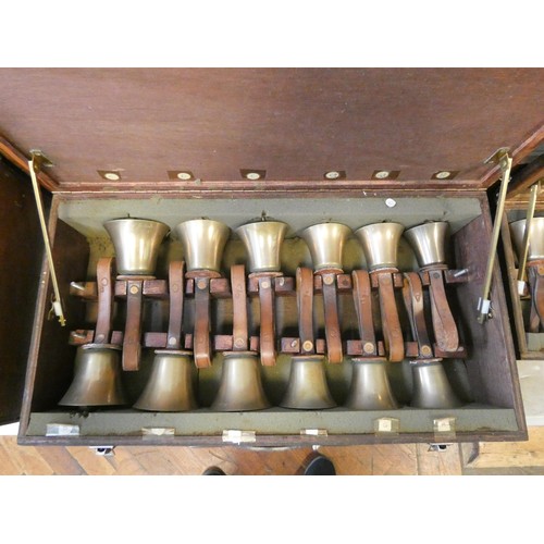 685 - 52 early 20th century campanology hand bells with leather straps, all contained within six wooden fi... 