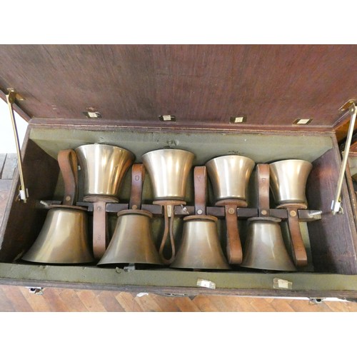 685 - 52 early 20th century campanology hand bells with leather straps, all contained within six wooden fi... 