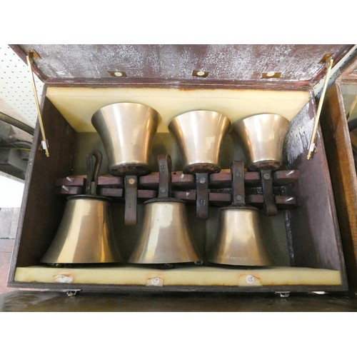 685 - 52 early 20th century campanology hand bells with leather straps, all contained within six wooden fi... 