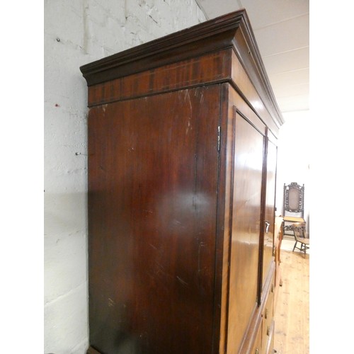 185 - A Georgian mahogany linen press, two shell inlaid cupboard doors with sliders within on a two short ... 