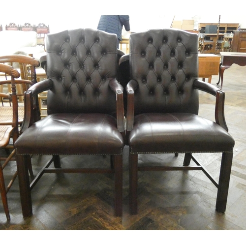 1 - A pair of Georgian style buttoned leather upholstered mahogany framed elbow chairs...