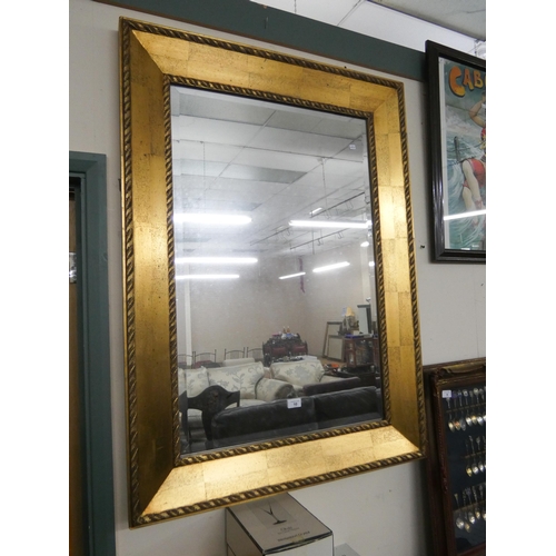 10 - A large Victorian style bevelled wall mirror in wide gilt frame  with leaf decoration, overall size ...