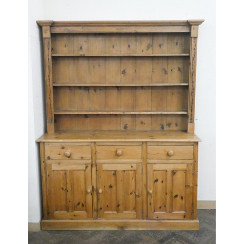 24 - A pine kitchen dresser with shelf back, three drawers and cupboards under, 5' wide...