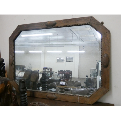 29 - A large oak framed wall mirror...