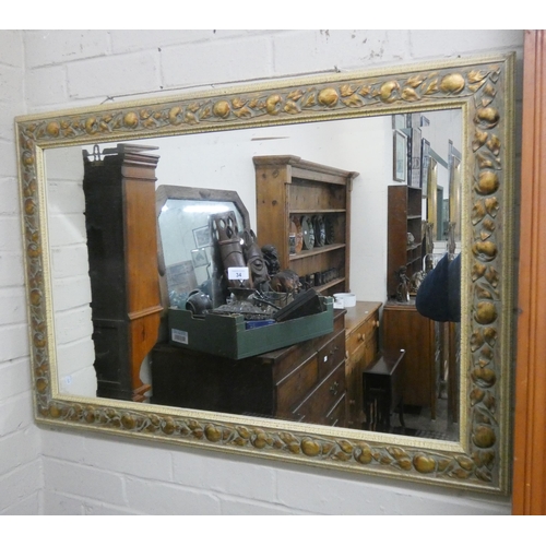 34 - A bevelled gilt framed wall mirror in fruit decorated frame...