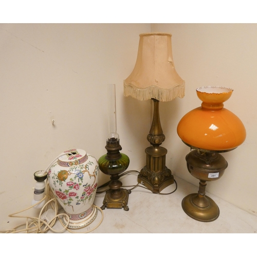 11 - A large brass table lamp, two oil lamps and a china table lamp