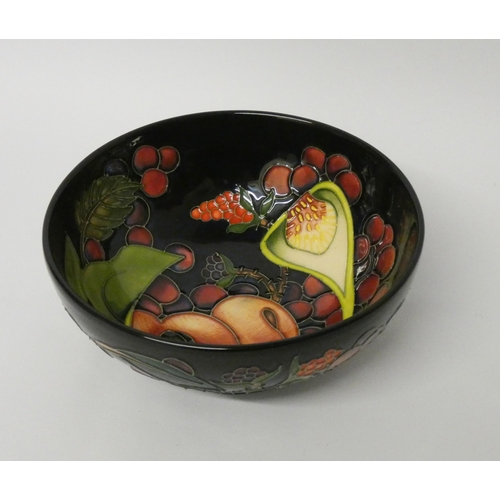 211 - A Moorcroft shallow bowl decorated in the Queen's Choice pattern with figs and grapes, dated 2000, i... 