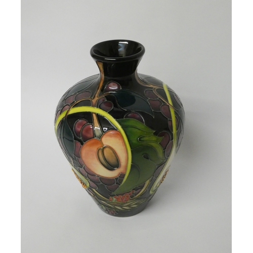 214 - A Moorcroft baluster shape vase decorated in the Queen's Choice pattern with figs and autumnal fruit... 