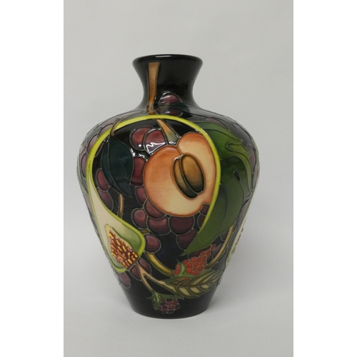 214 - A Moorcroft baluster shape vase decorated in the Queen's Choice pattern with figs and autumnal fruit... 