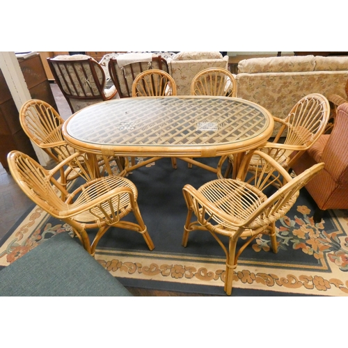 126 - A modern bamboo conservatory or patio suite comprising oval glass top table and six elbow chairs