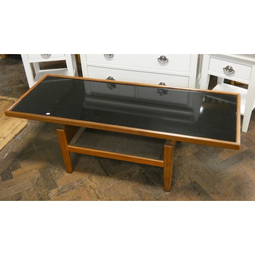 131 - A long two tier teak coffee table with black glass top