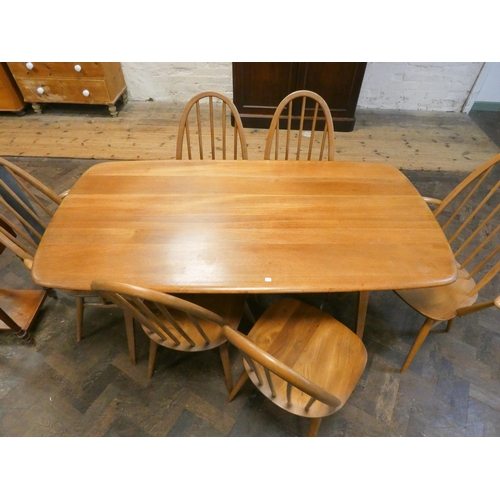 147 - Ercol - a  blonde elm dining table and six high spindle back chairs comprising four standards and tw... 