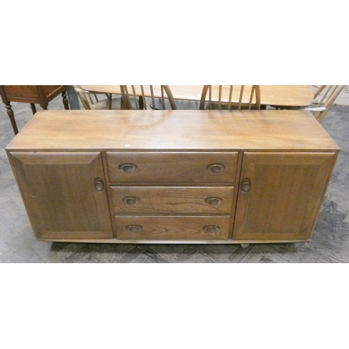 148 - Ercol - a blonde elm long low sideboard fitted three centre drawers and cupboards on casters, 61