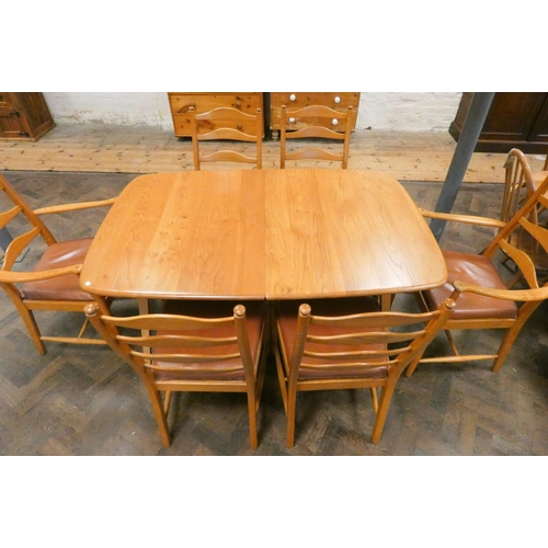 150 - Ercol - A modern blonde  extending dining table with two leaves and a set of six ladder back chairs ... 