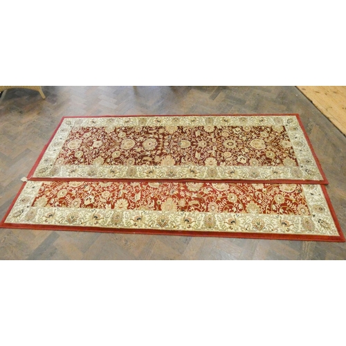 172 - A pair of red and cream pattern Wilton carpet runners, each 7'6 long