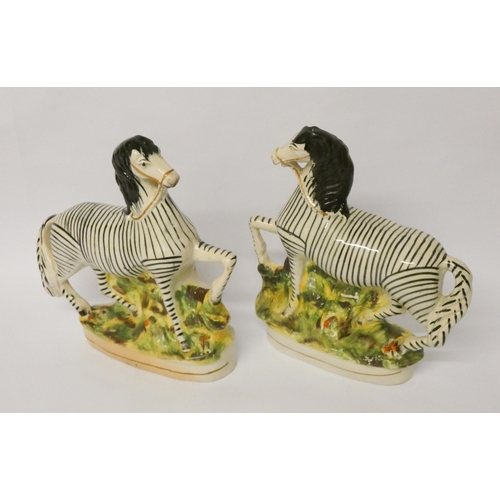 198 - A pair of late 19th century Staffordshire flat back figures of Zebra, 22 cms tall