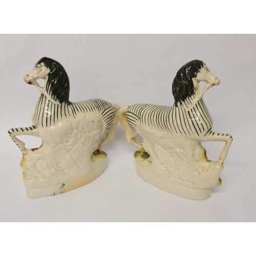 198 - A pair of late 19th century Staffordshire flat back figures of Zebra, 22 cms tall