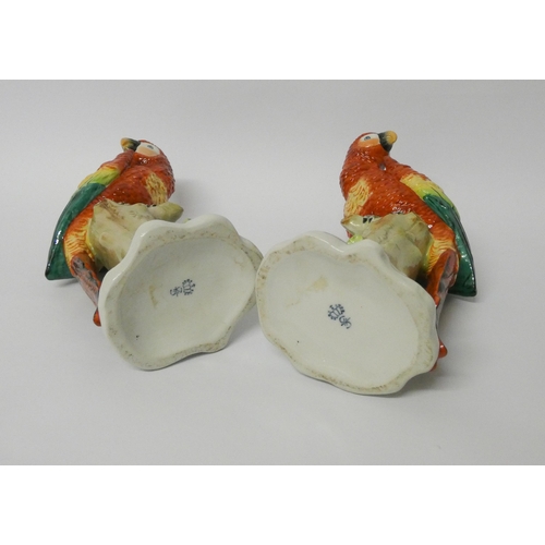 238 - Pair of Sitzendorf porcelain parrots, naturalistically modelled seated on tree stumps, blue printed ... 