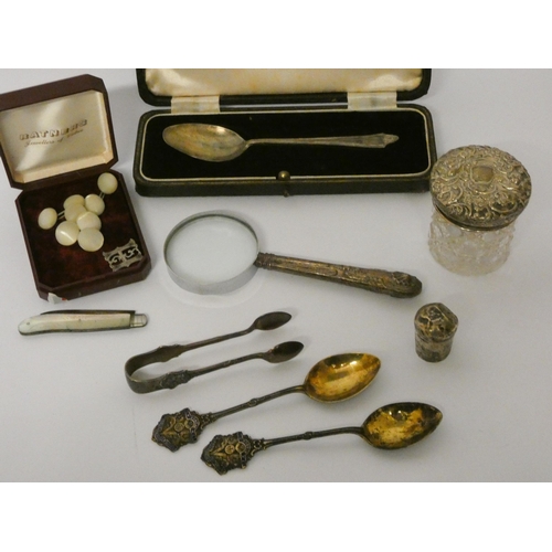 651 - Small silver ware - spoons, silver handled magnifying glass, nips, mother of pearl fruit knife, cuff... 