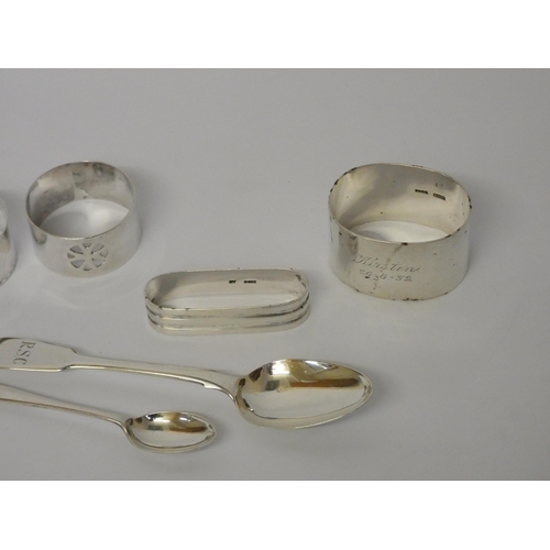 674 - A collection of four assorted silver napkin rings and two silver spoons, gross weight 3.8 troy oz