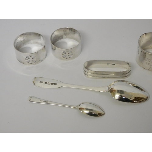 674 - A collection of four assorted silver napkin rings and two silver spoons, gross weight 3.8 troy oz