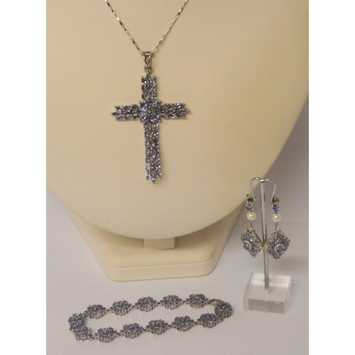 558 - Large silver and tanzanite cross pendant on silver chain and a silver and tanzanite cluster bracelet... 