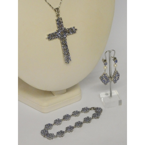 558 - Large silver and tanzanite cross pendant on silver chain and a silver and tanzanite cluster bracelet... 