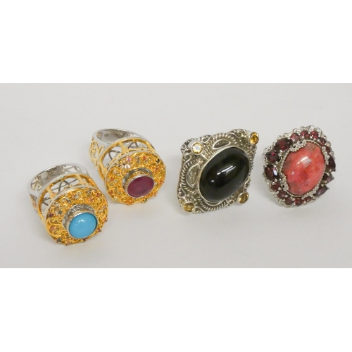 559 - Four large and impressive gem stone silver dress rings.