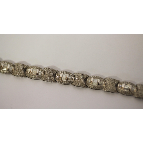 582 - Diamond bracelet with three carats of baguette and brilliant cut diamonds in 9ct white gold.  With c... 