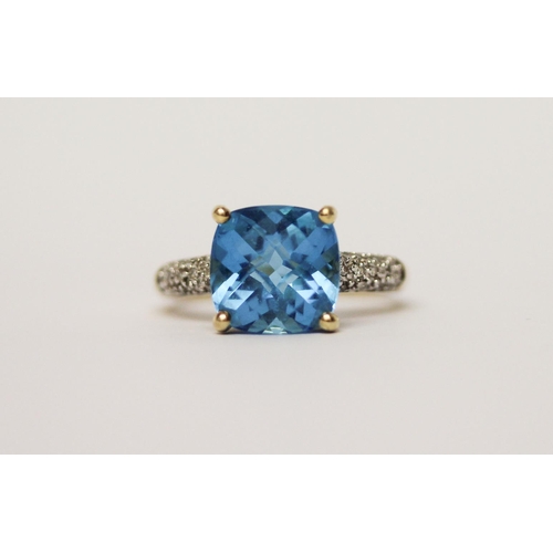 597 - A Swiss blue topaz and diamond dress ring on 9ct gold band, ring size M, in Tiffany box.