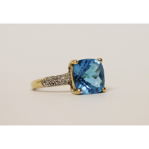 597 - A Swiss blue topaz and diamond dress ring on 9ct gold band, ring size M, in Tiffany box.