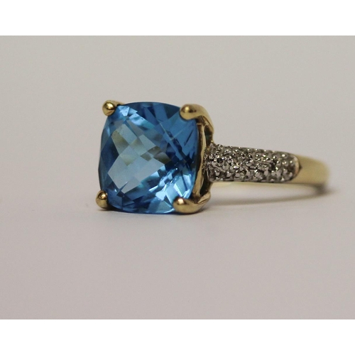 597 - A Swiss blue topaz and diamond dress ring on 9ct gold band, ring size M, in Tiffany box.