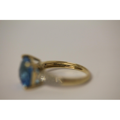 597 - A Swiss blue topaz and diamond dress ring on 9ct gold band, ring size M, in Tiffany box.