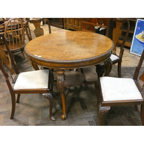 323 - A 1920's Burr walnut and cross banded circular centre dining table on cabriole legs united with an u... 