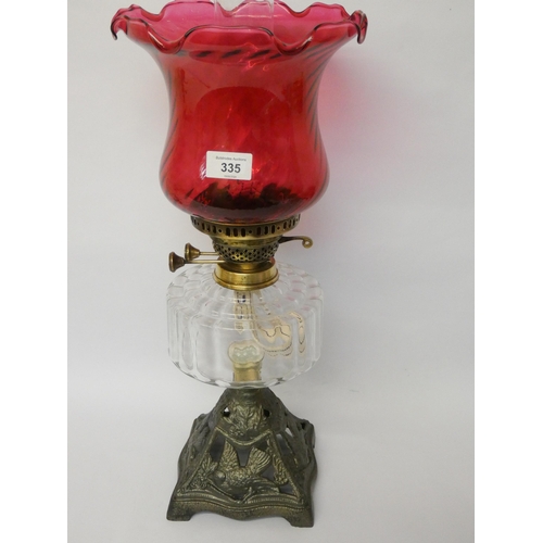 335 - Victorian oil lamp with brass mounts and cranberry glass shade